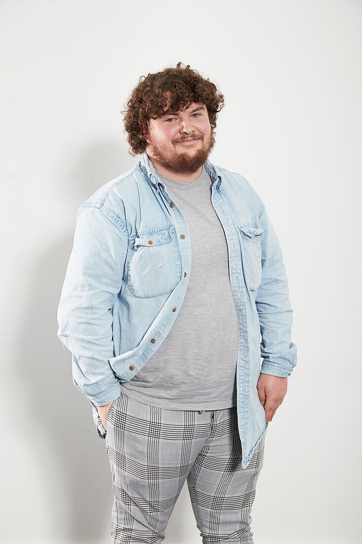 Portrait young man in denim shirt and plaid pants