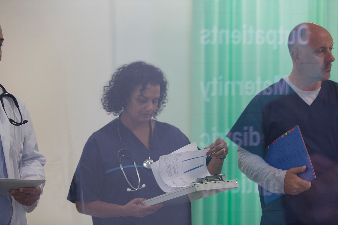 Female doctor reviewing medical chart in hospital
