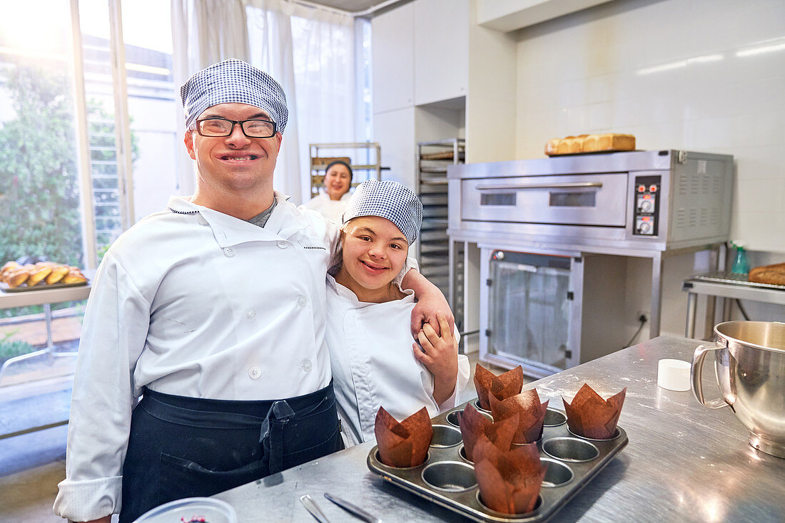 Portrait happy students with Down Syndrome in baking class