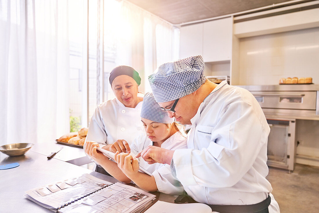 Chef and students with Down Syndrome using tablet