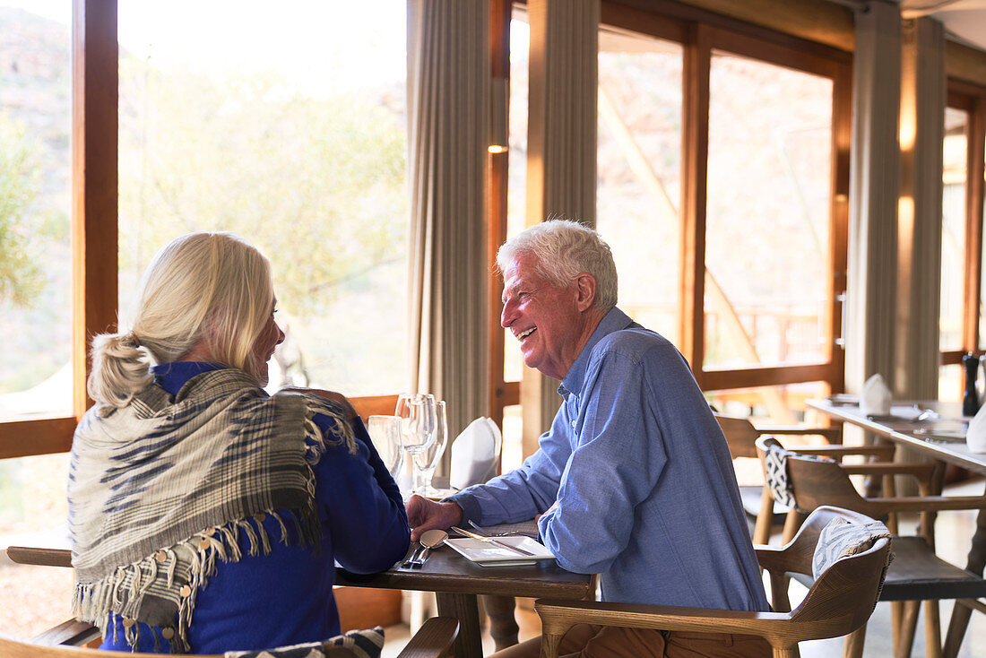 Happy senior couple dining in restaurant