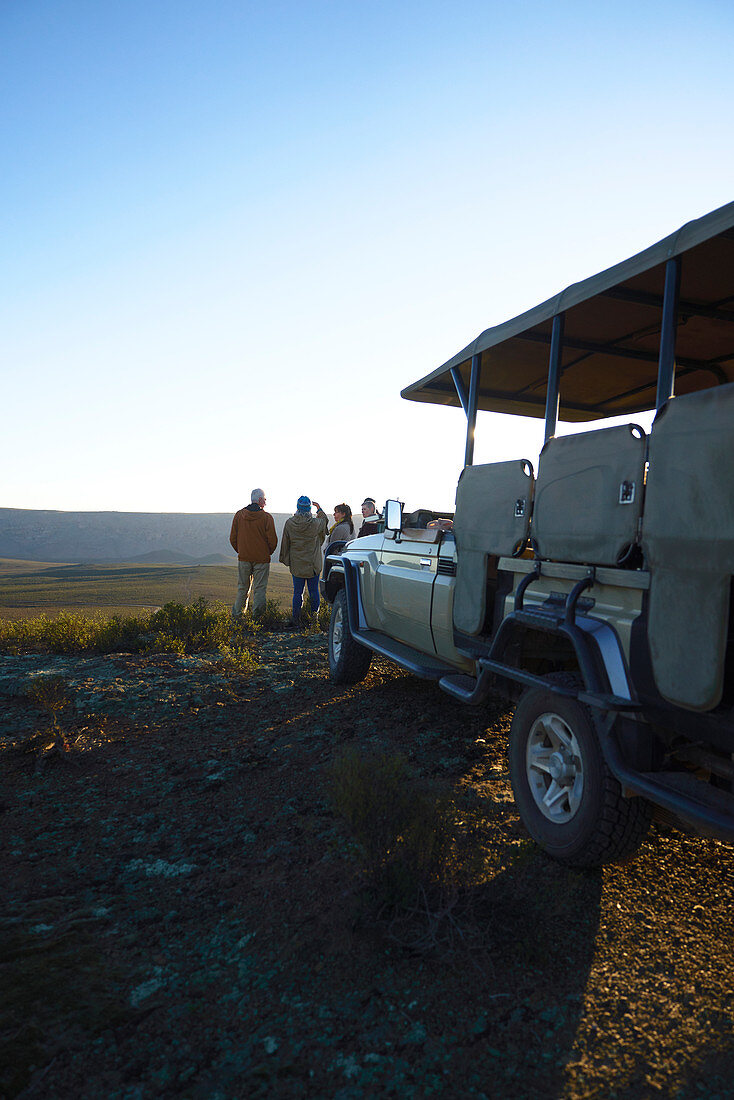 Group and off-road vehicle on hill South Africa