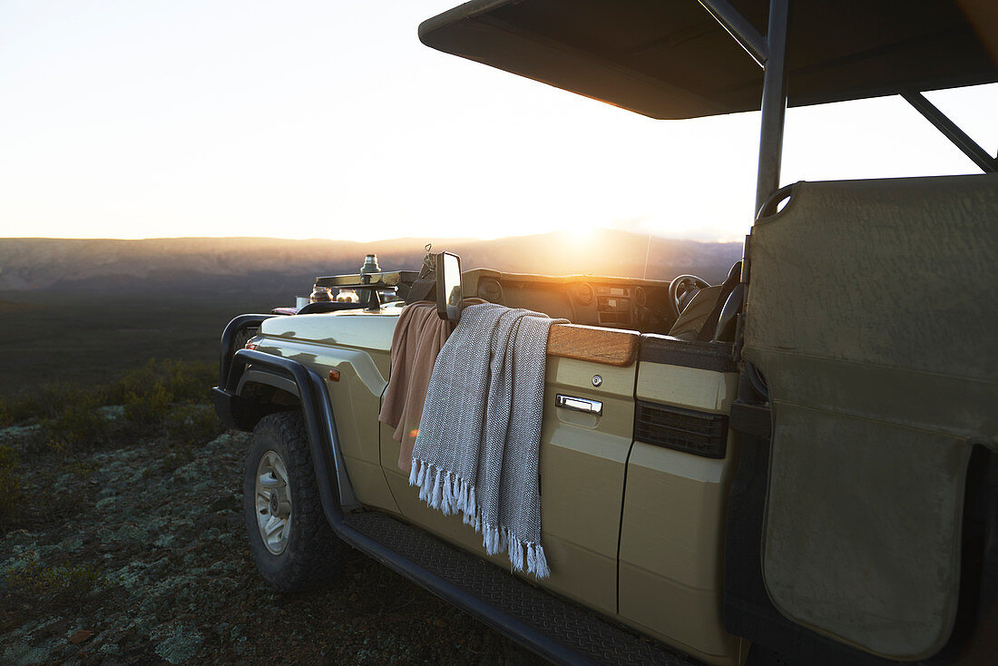 Sunrise behind safari off-road vehicle South Africa