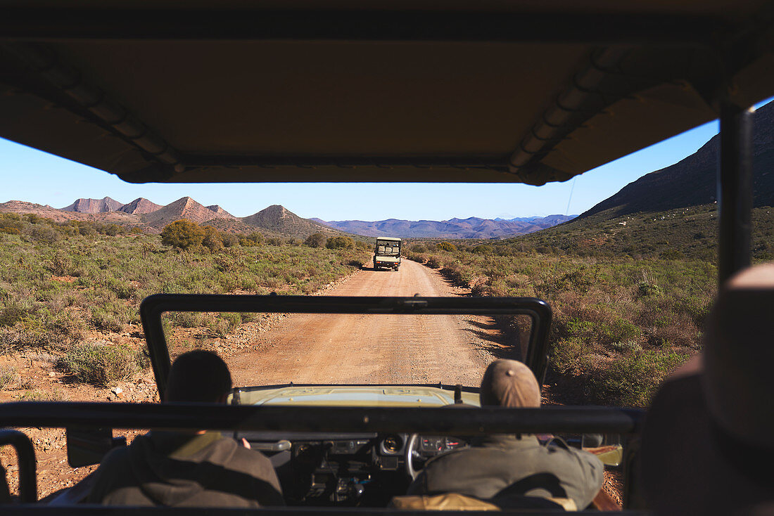 Guide drive off-road vehicle sunny dirt road South Africa