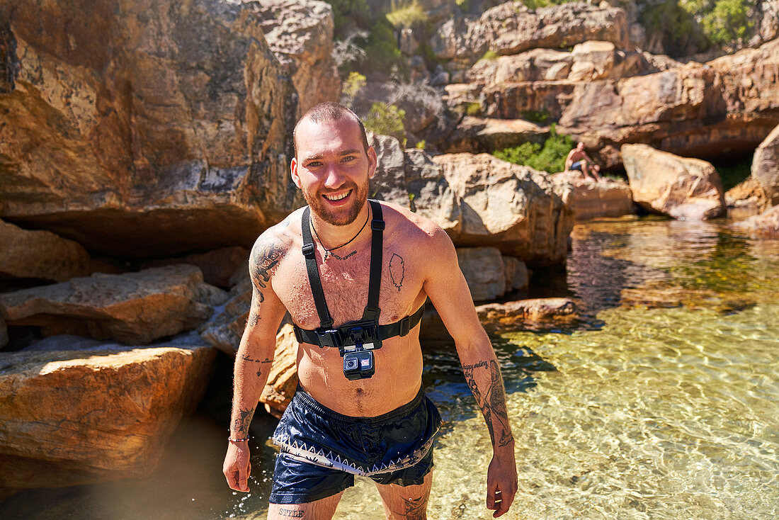 Portrait young man with wearable camera swimming