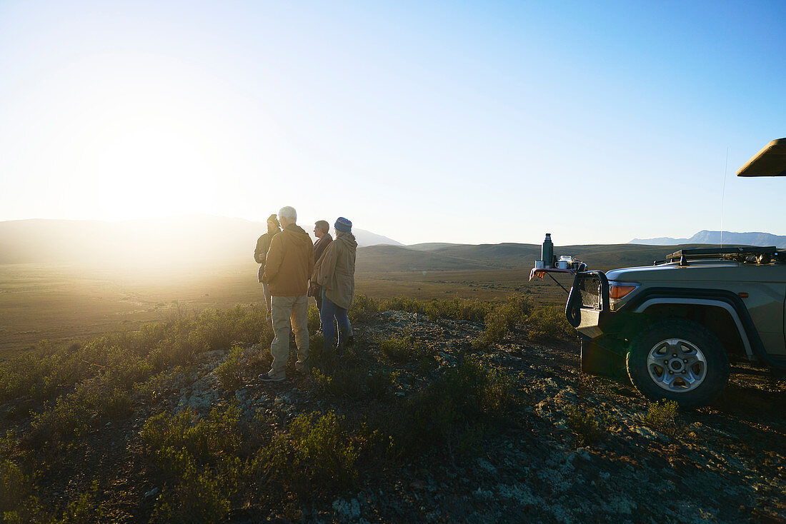 Group enjoying idyllic sunrise from hill South Africa