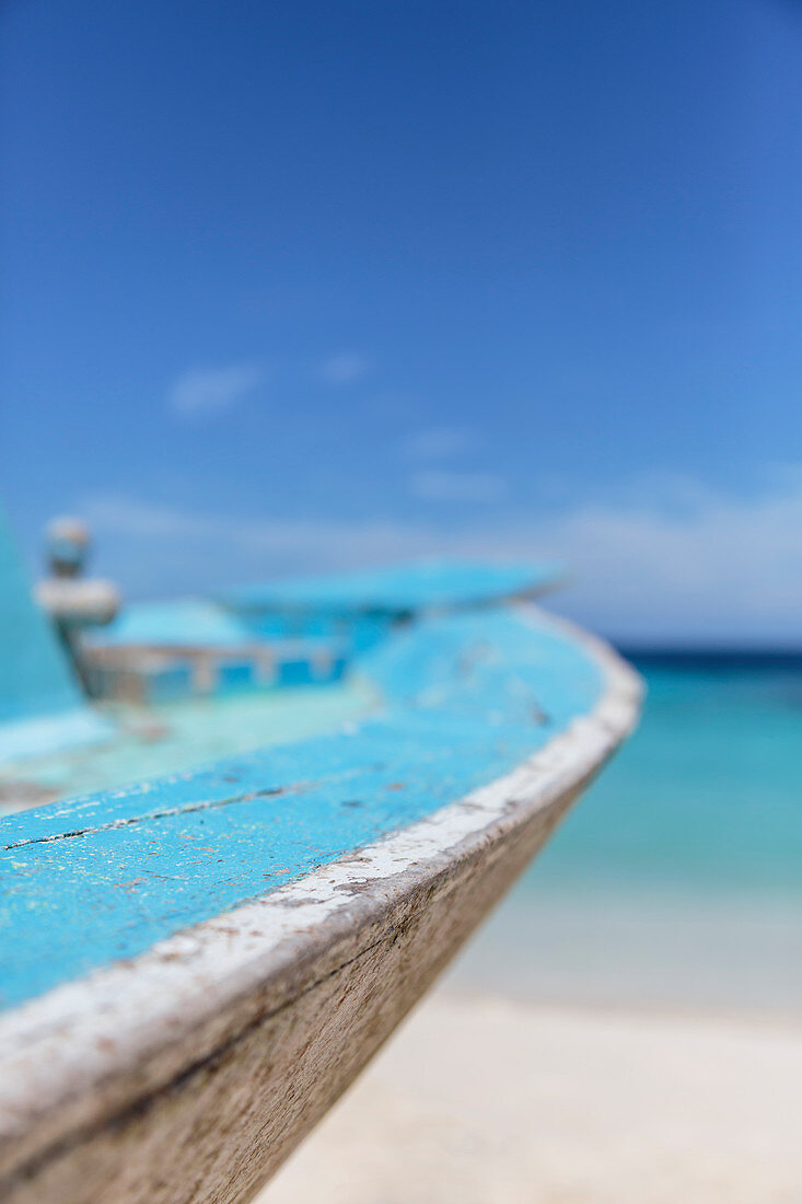 Close up turquoise blue boat on beach, Maldives