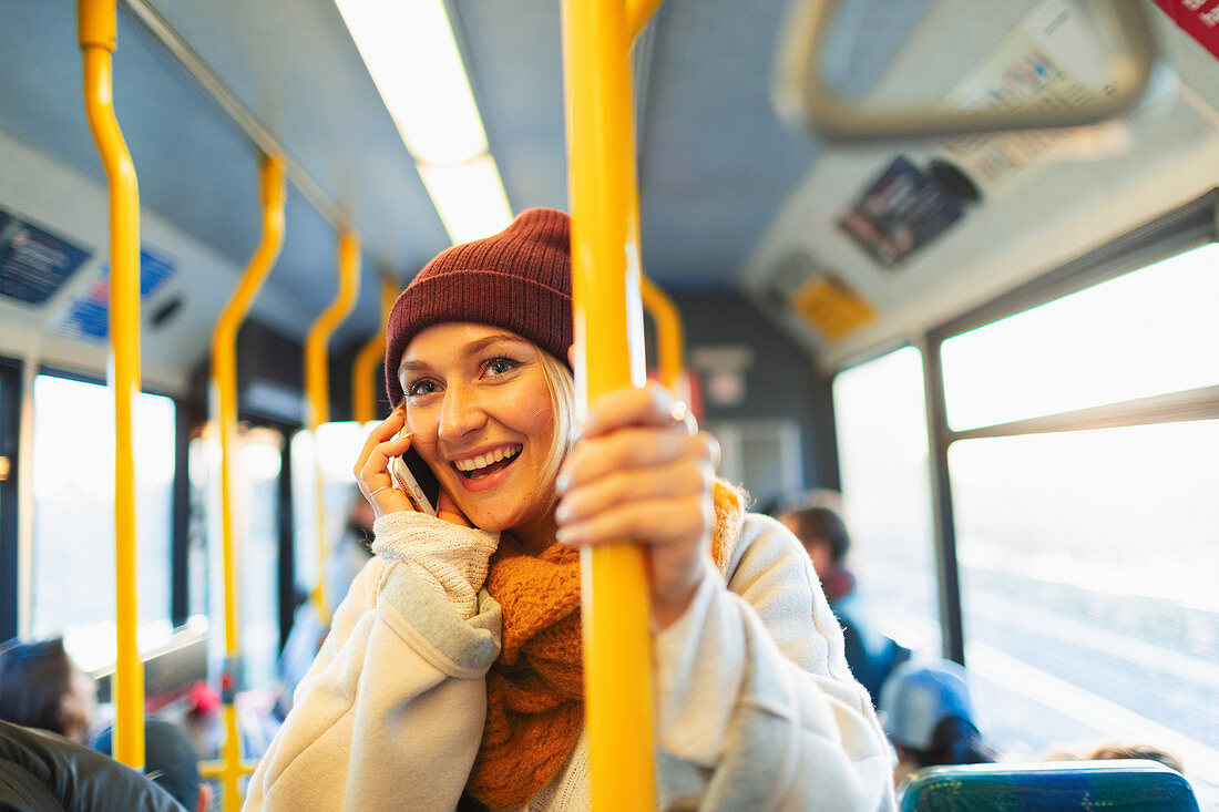 Woman talking on smart phone on bus