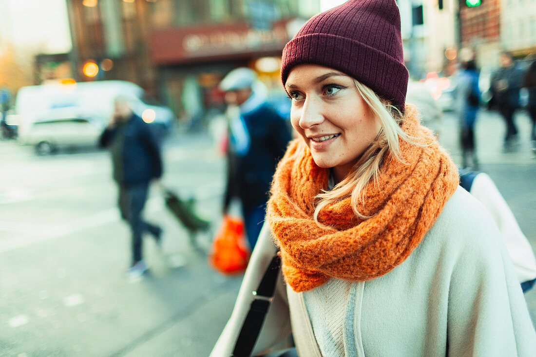 Woman in stocking cap and scarf on urban street