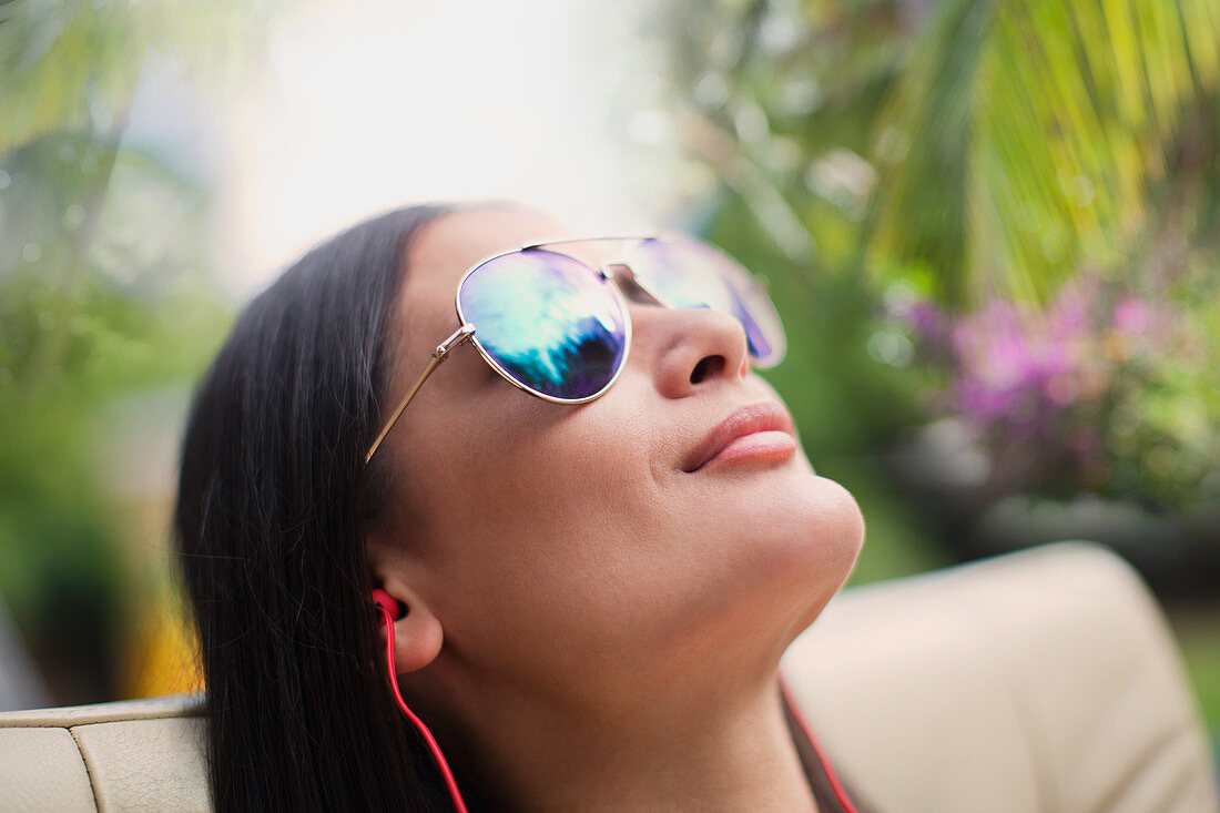 Close up serene woman in sunglasses sunbathing