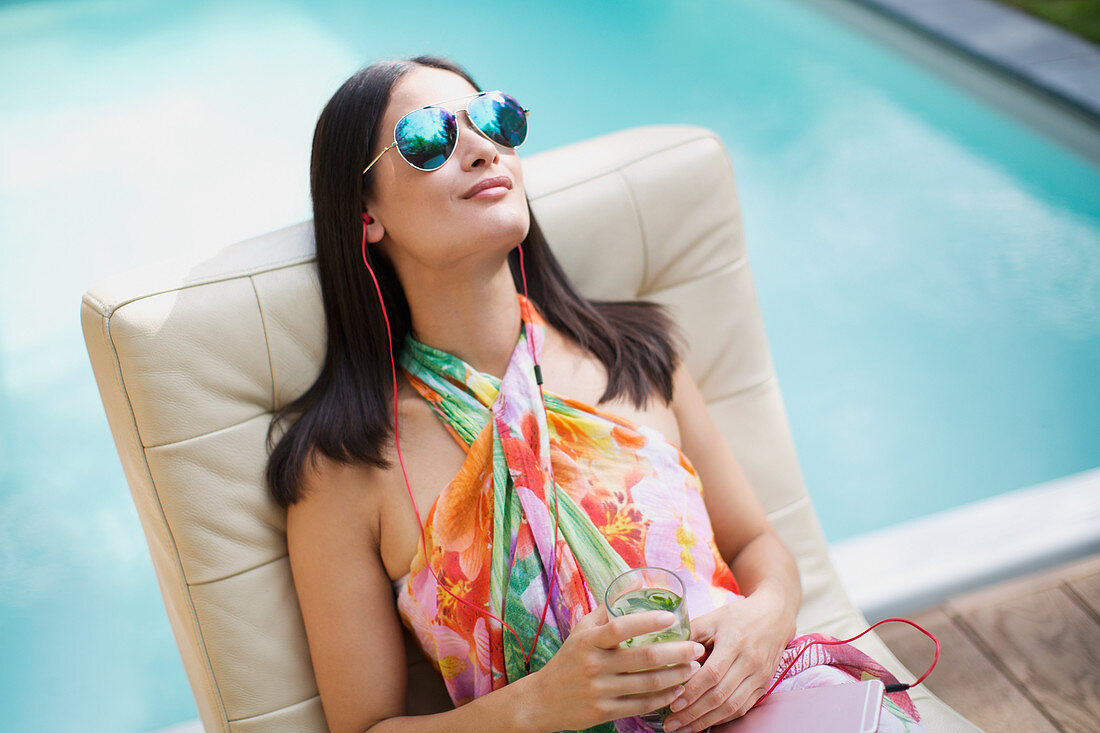 Woman with sunglasses at summer poolside