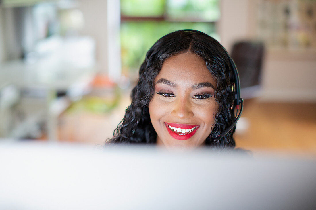 Woman with headset working at computer