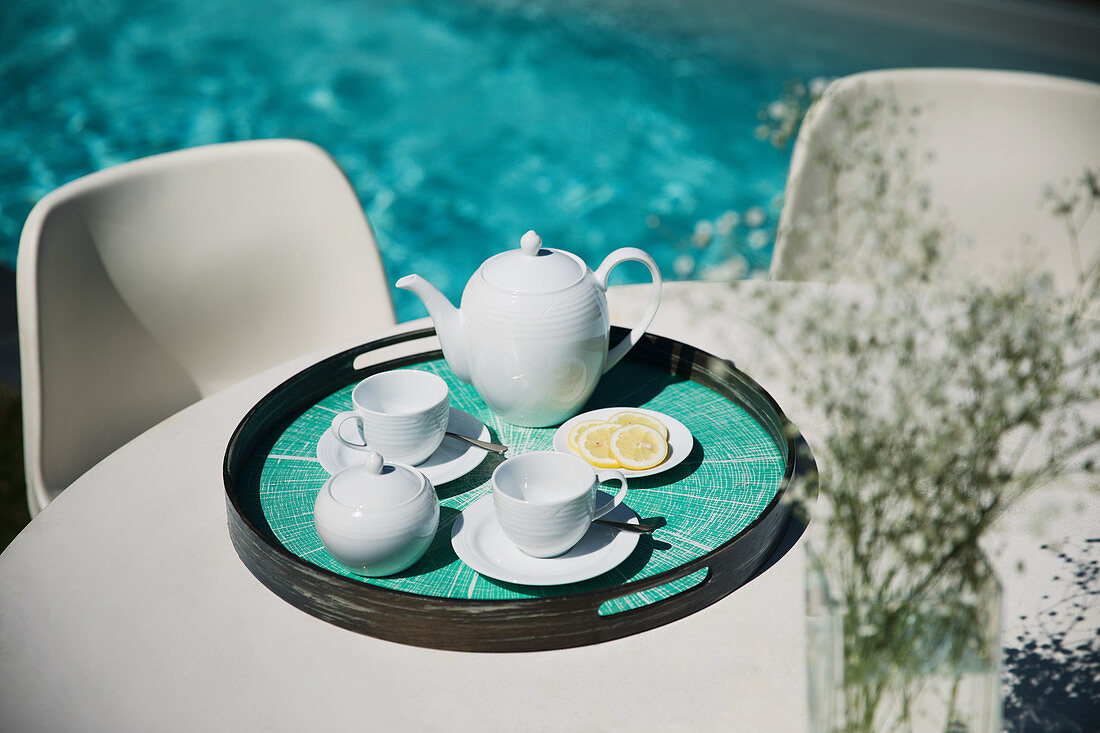 Tea service on poolside patio table