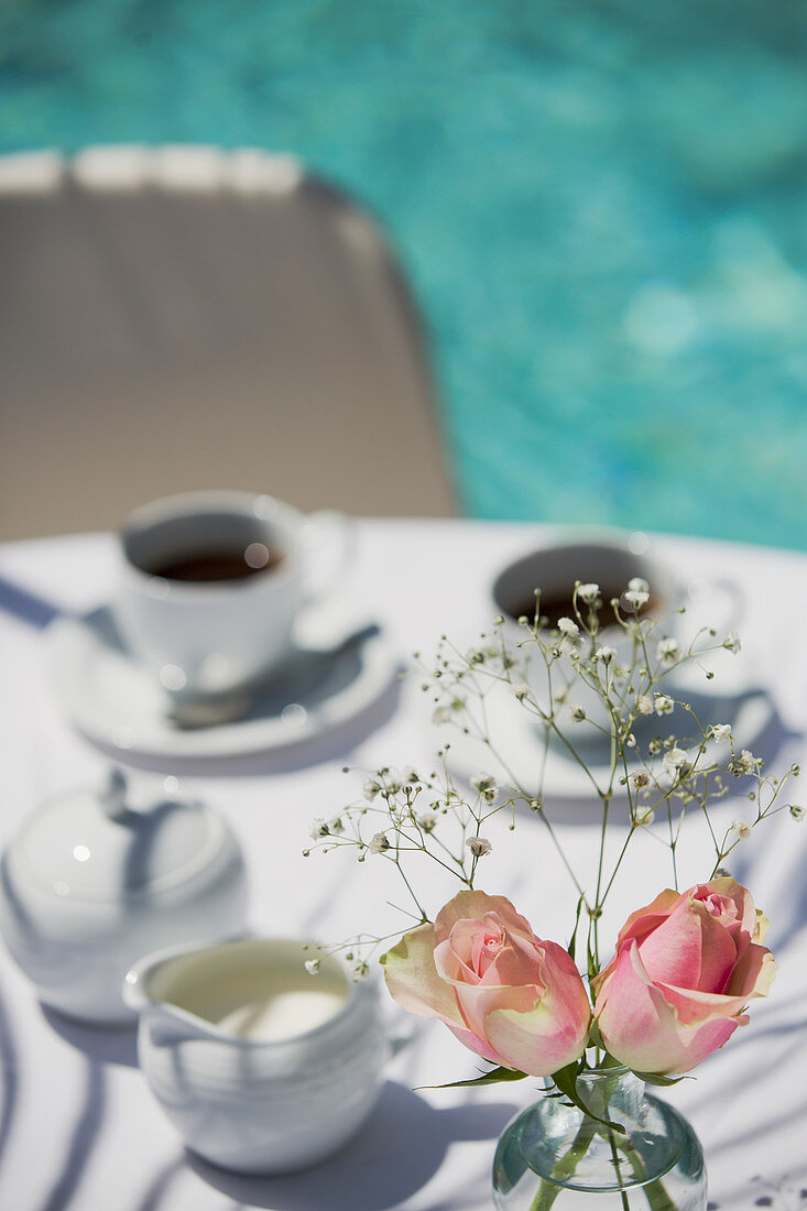 Roses and coffee on patio table