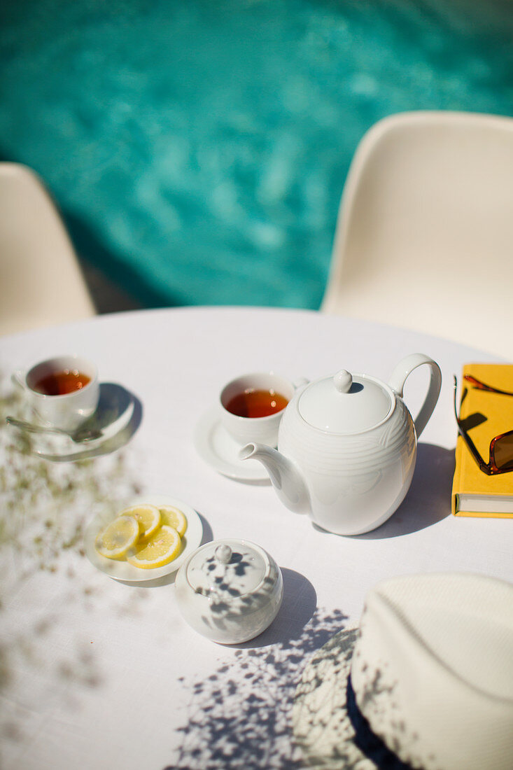 Tea service on summer poolside patio table