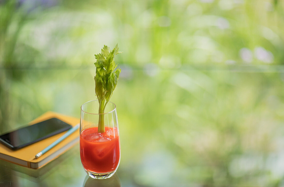 Bloody Mary cocktail with celery stalk on table