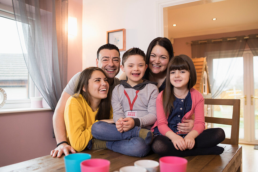 Portrait happy family with Down Syndrome child