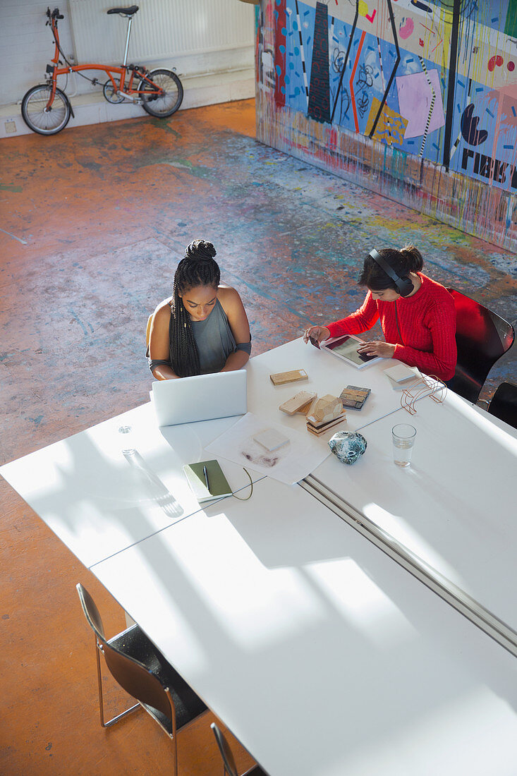 Creative businesswomen working at conference table
