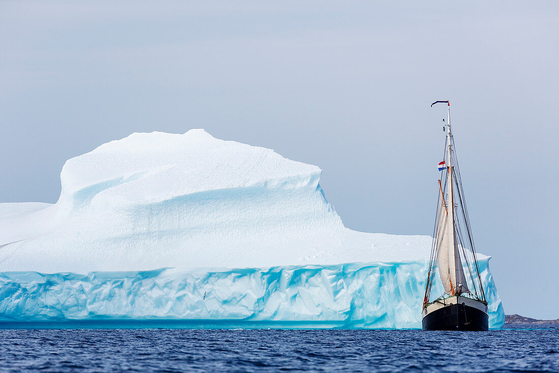 Ship sailing along majestic iceberg on
