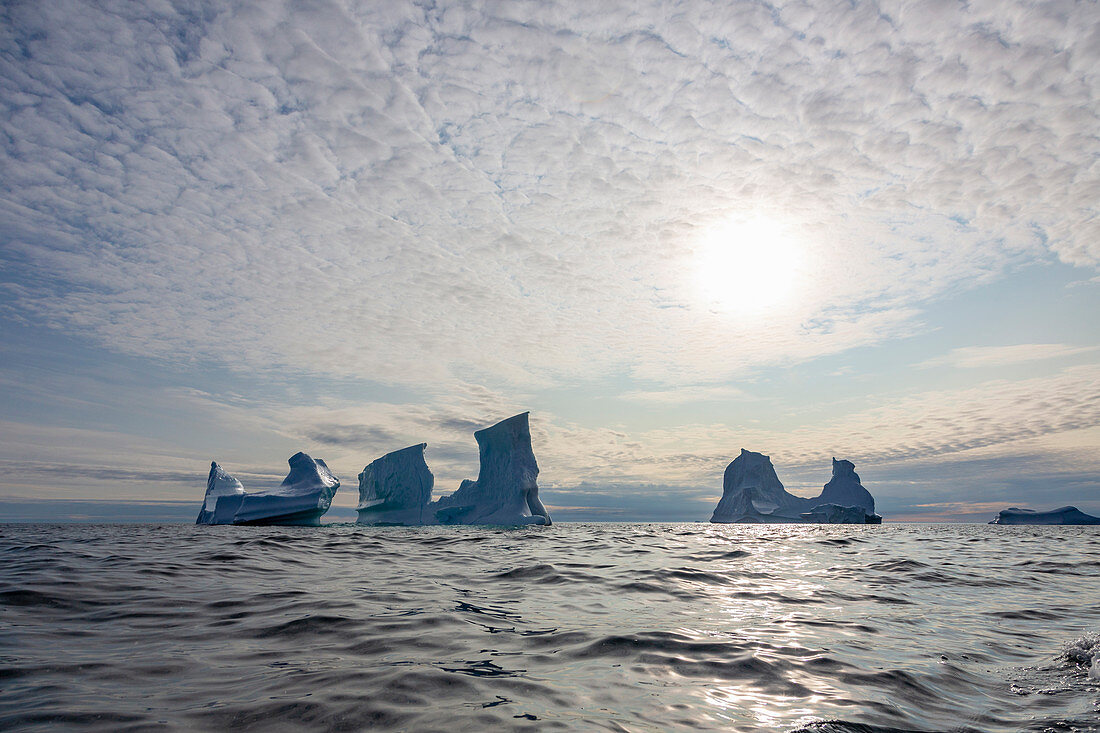 Majestic icebergs below sky on Atlantic Ocean Greenland