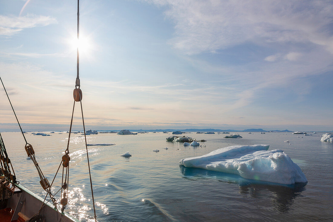 Ship sailing past melting ice on Atlantic Ocean Greenland