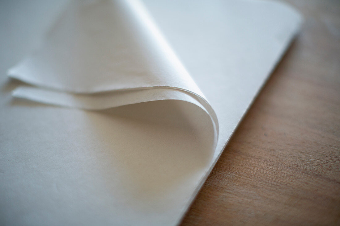 Close up folded corner of white tissue paper