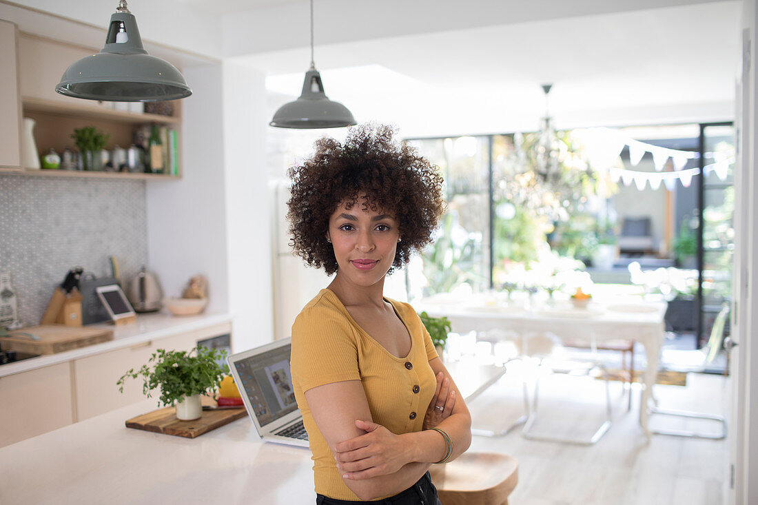 Portrait female freelancer in kitchen