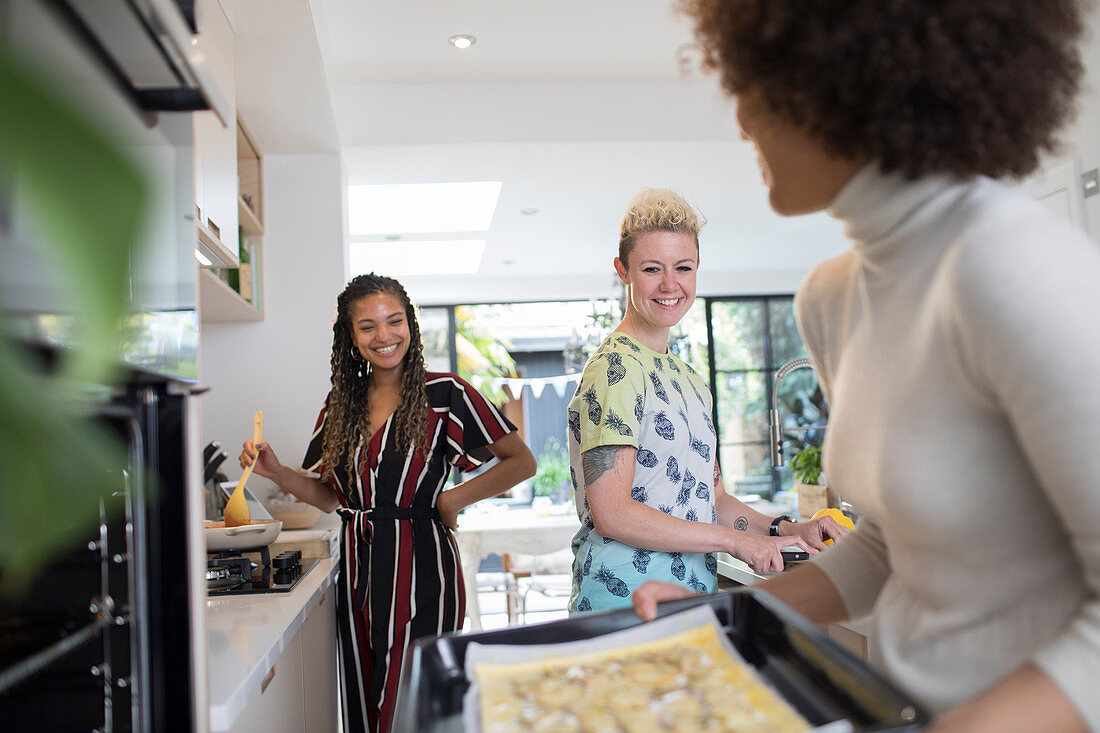 Women friends cooking in kitchen