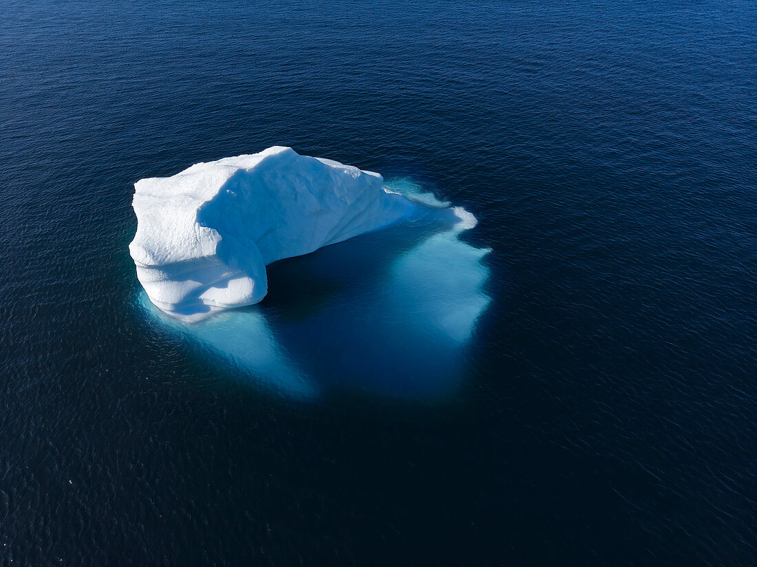 Drone point of view majestic iceberg on blue