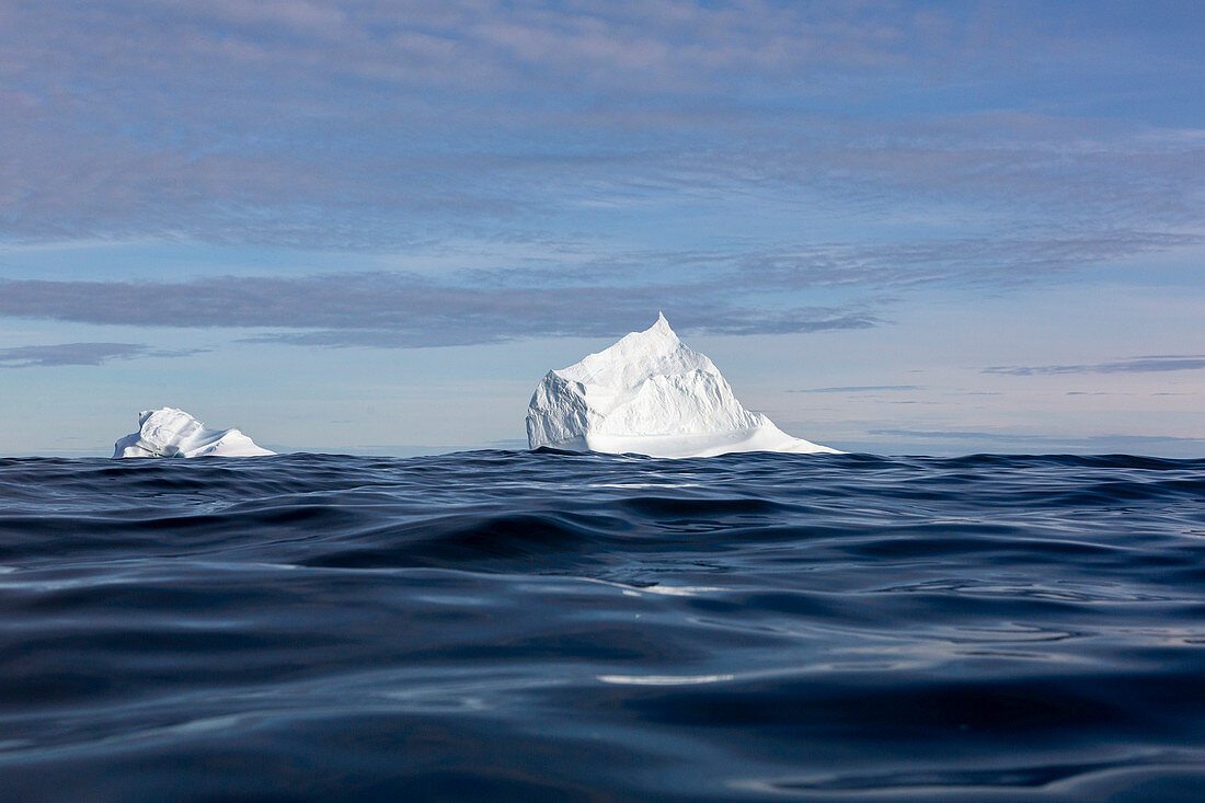 Majestic iceberg formations over blue ocean