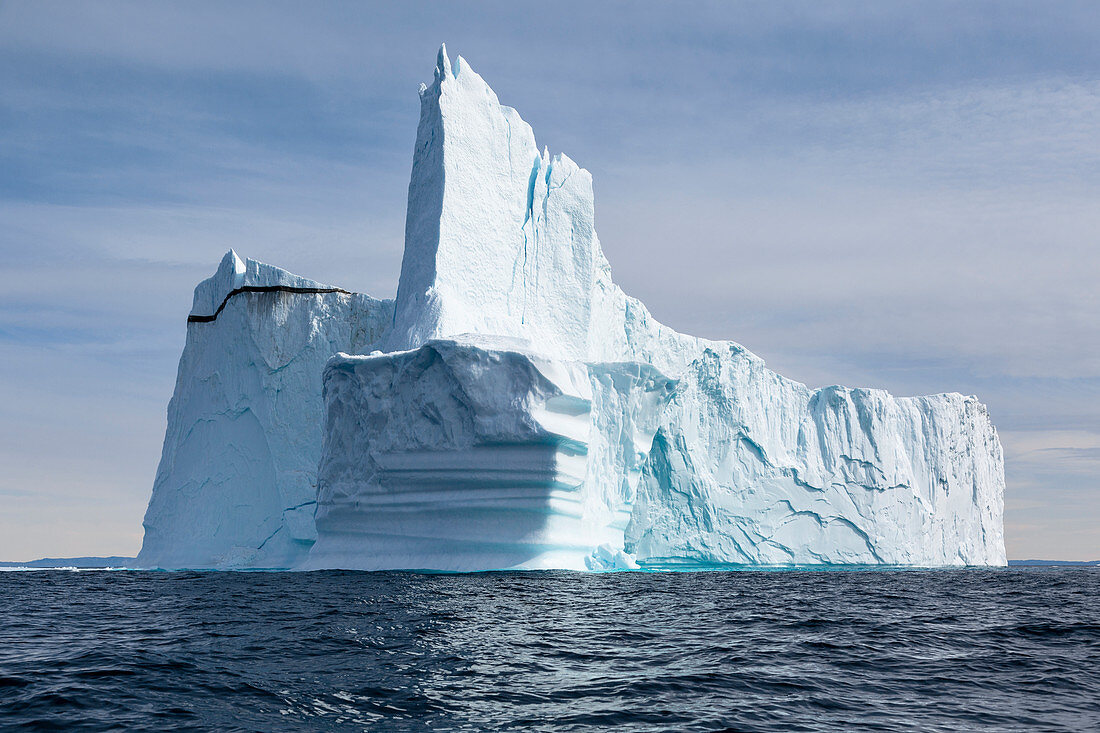 Majestic towering iceberg on blue Atlantic Ocean Greenland