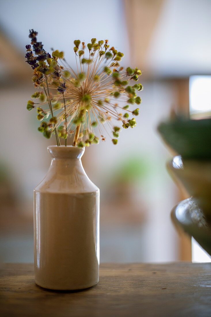 Rustic flower stems in ceramic vase