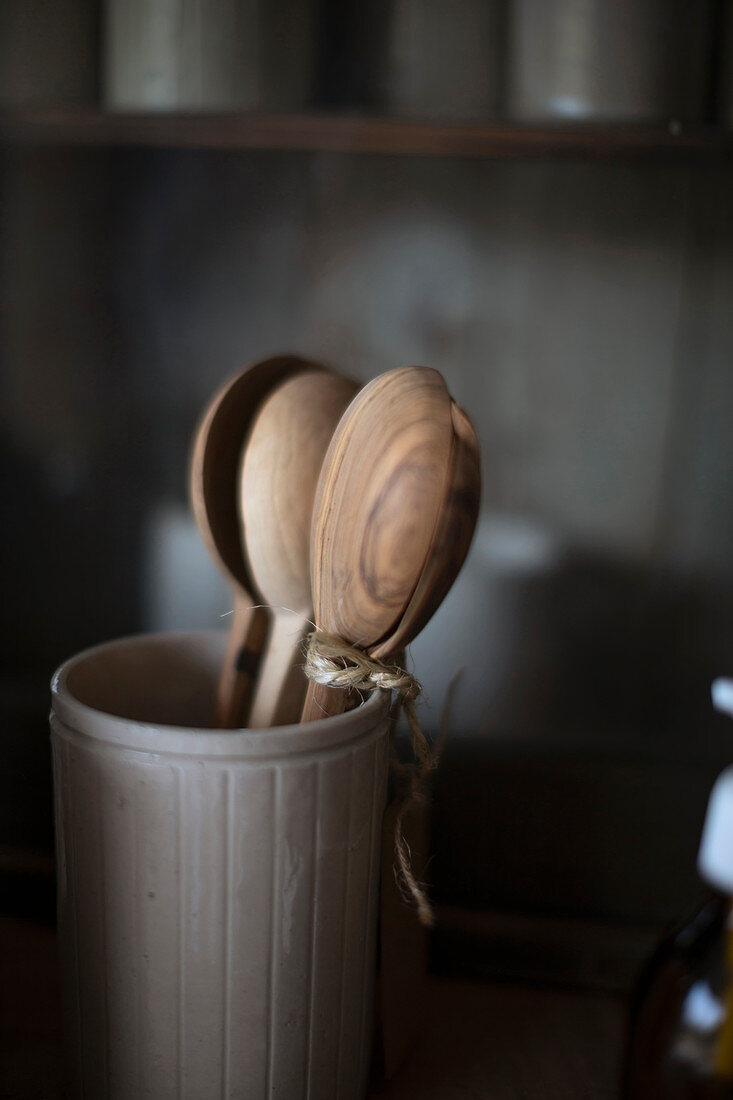 Rustic wooden spoons in ceramic crock