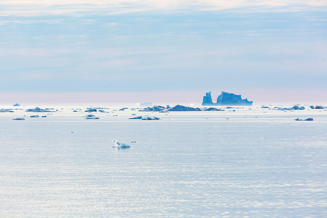 Melting icebergs on vast tranquil Atlantic Ocean Greenland