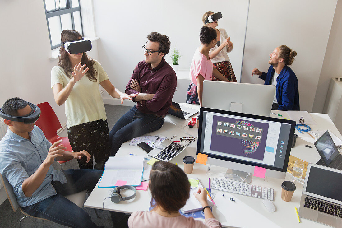 Computer programmers testing virtual reality glasses