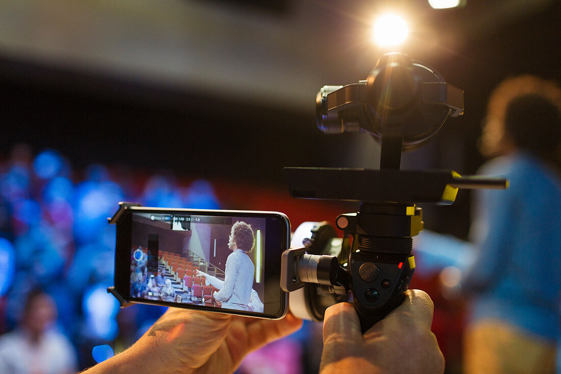 Cameraman videoing speaker on stage