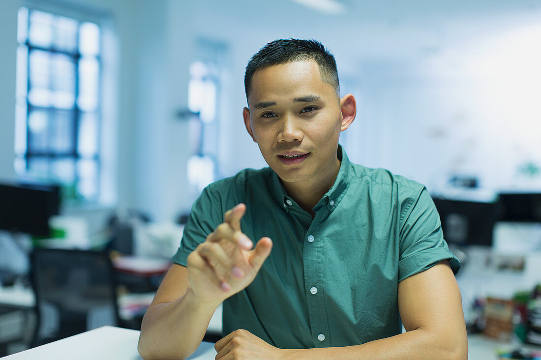 Portrait businessman talking in office