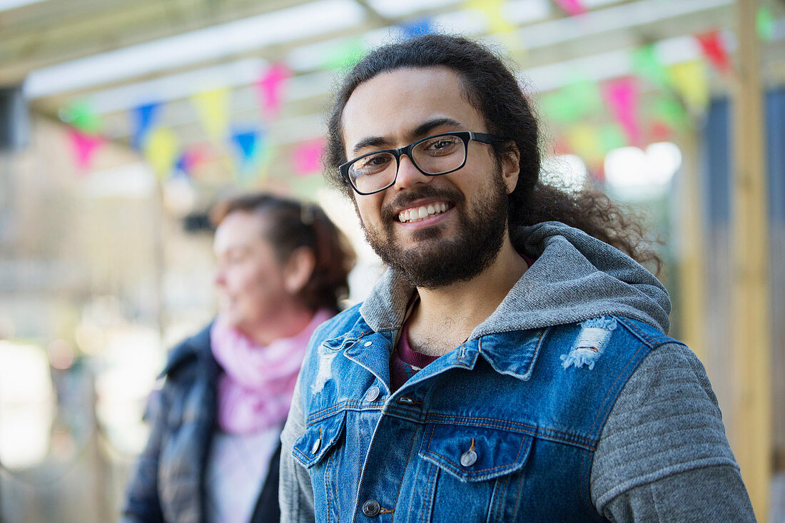 Portrait smiling young man with beard and long hair