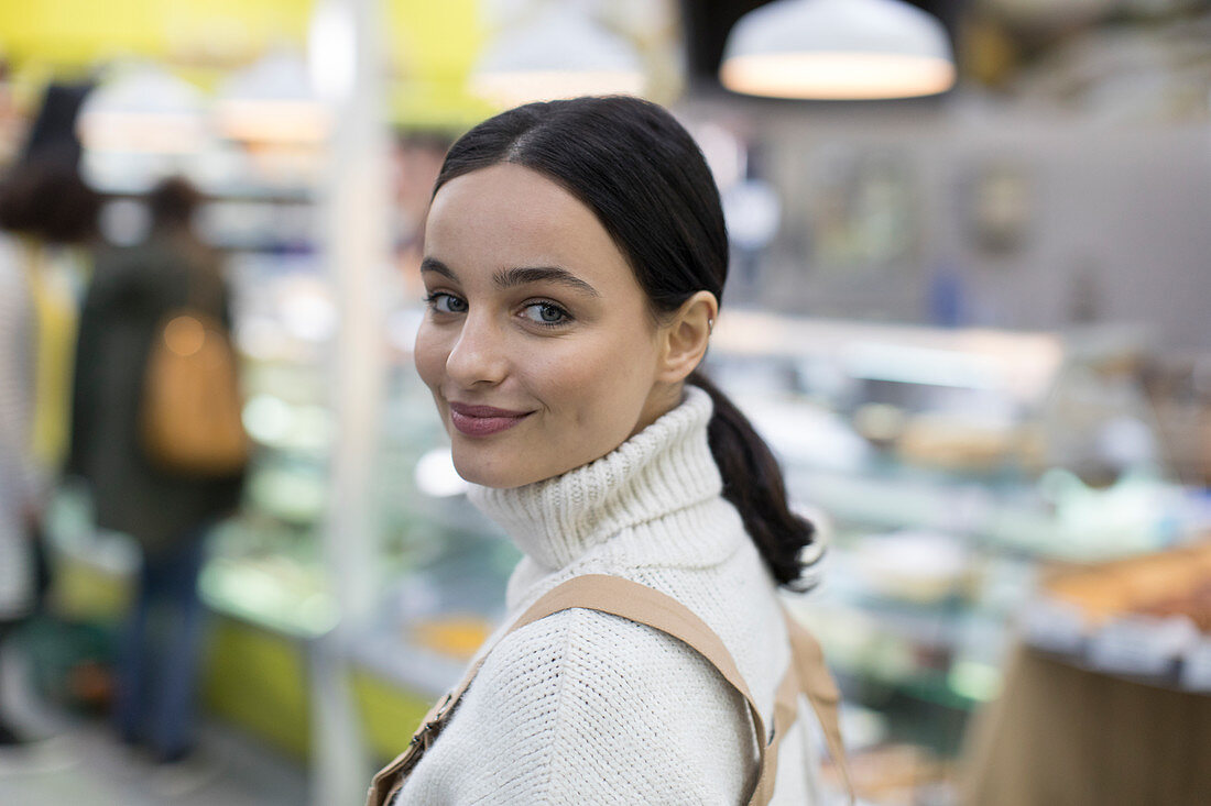 Portrait confident young woman in supermarket
