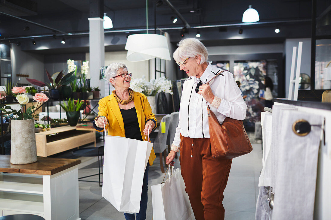 Senior women leaving home goods store with shopping bags