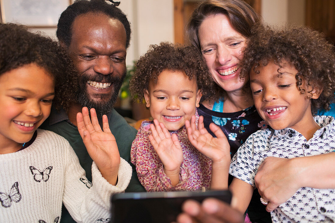 Multiethnic family video chatting with smart phone