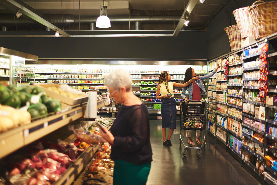 Women grocery shopping in supermarket