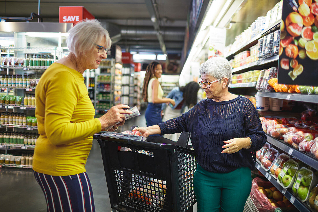 Senior women grocery shopping in supermarket