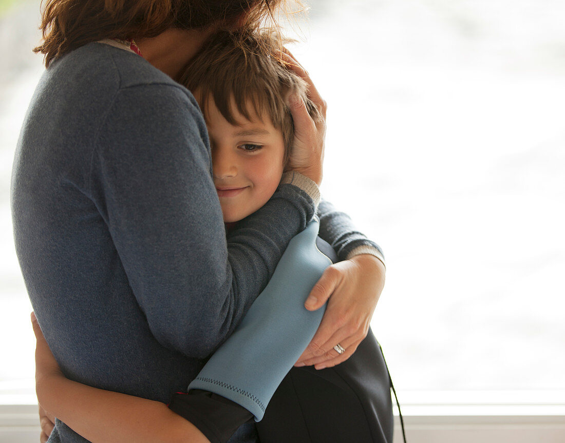 Mother and son hugging