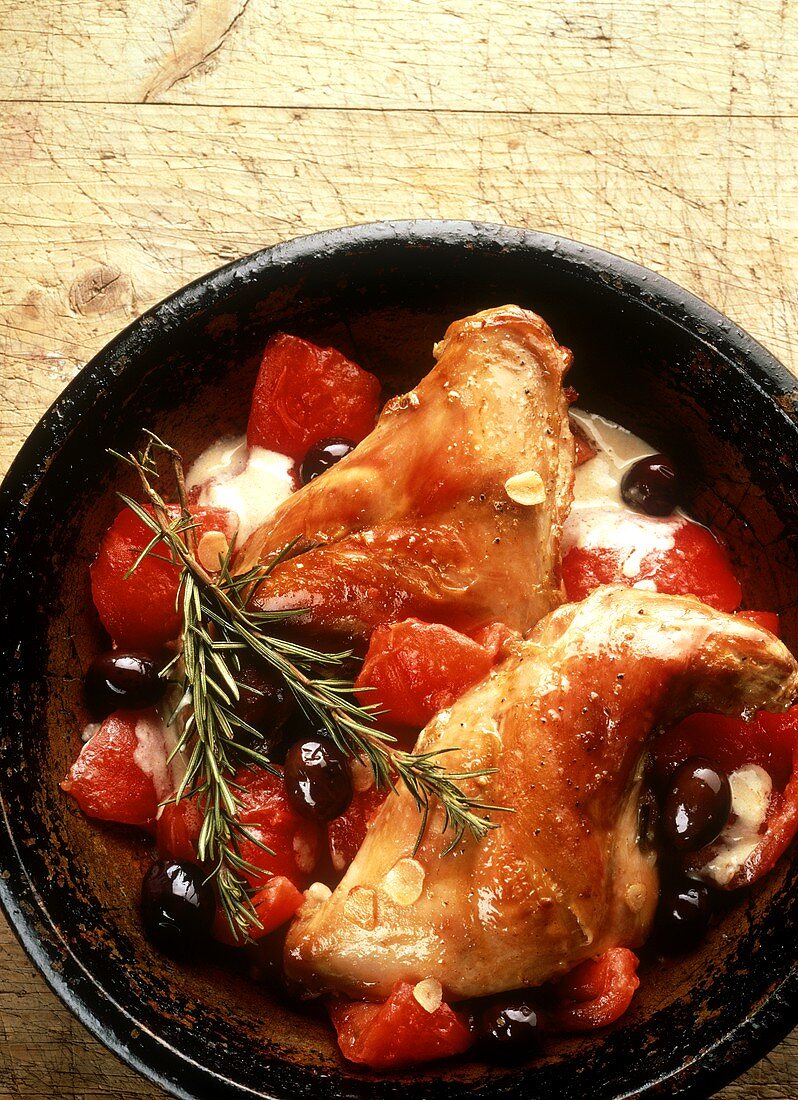 Chicken thigh with tomatoes, olives, garlic, rosemary