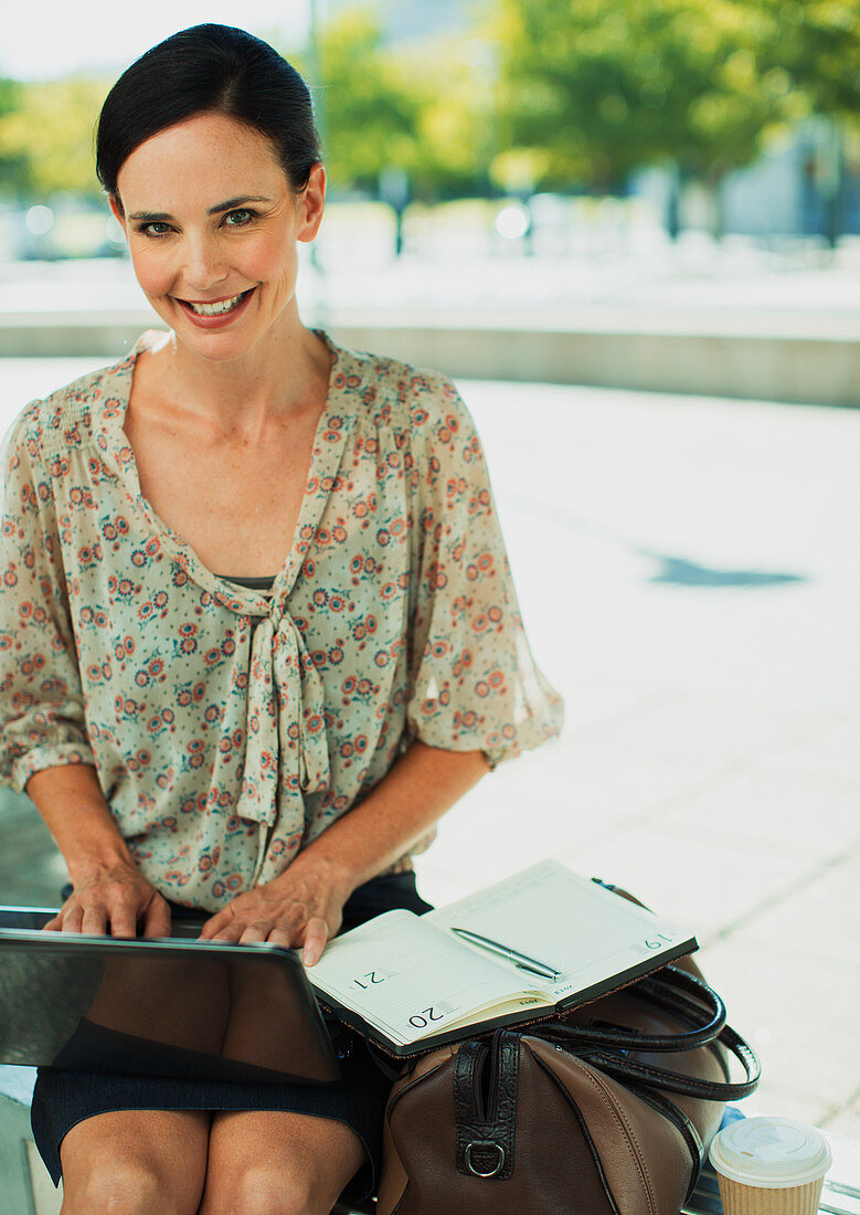 Smiling businesswoman working outdoors