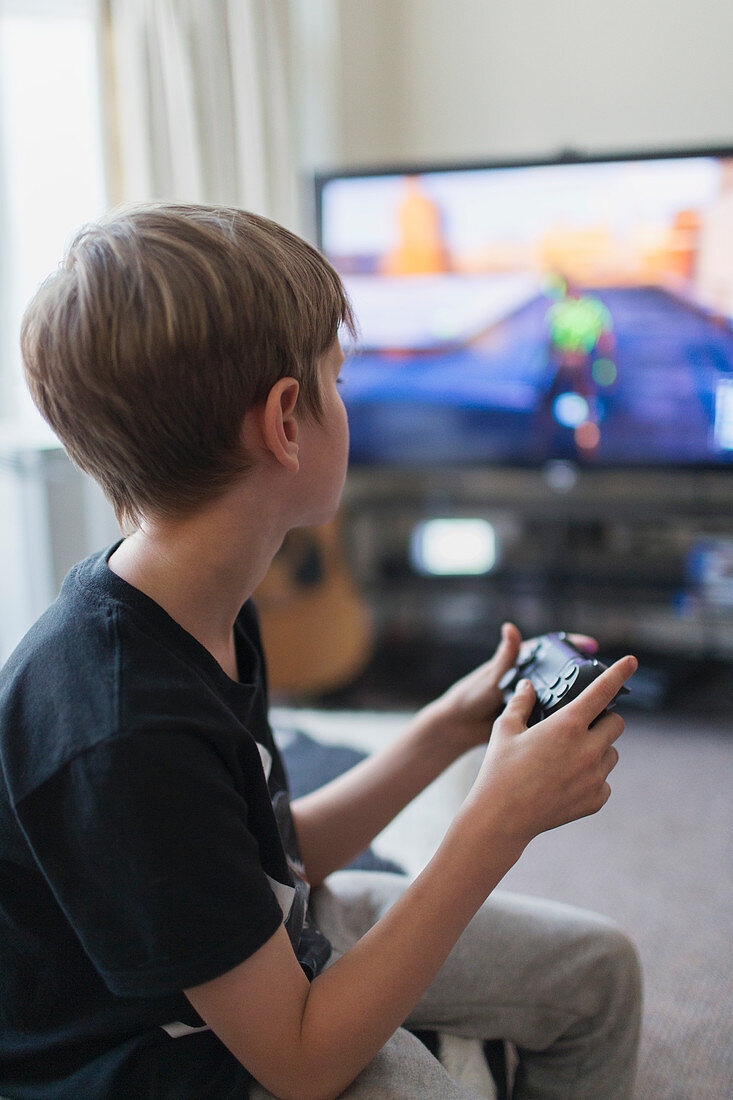 Boy playing video game at TV