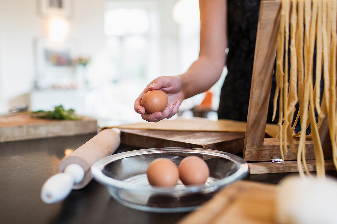 Woman making fresh homemade pasta in kitchen