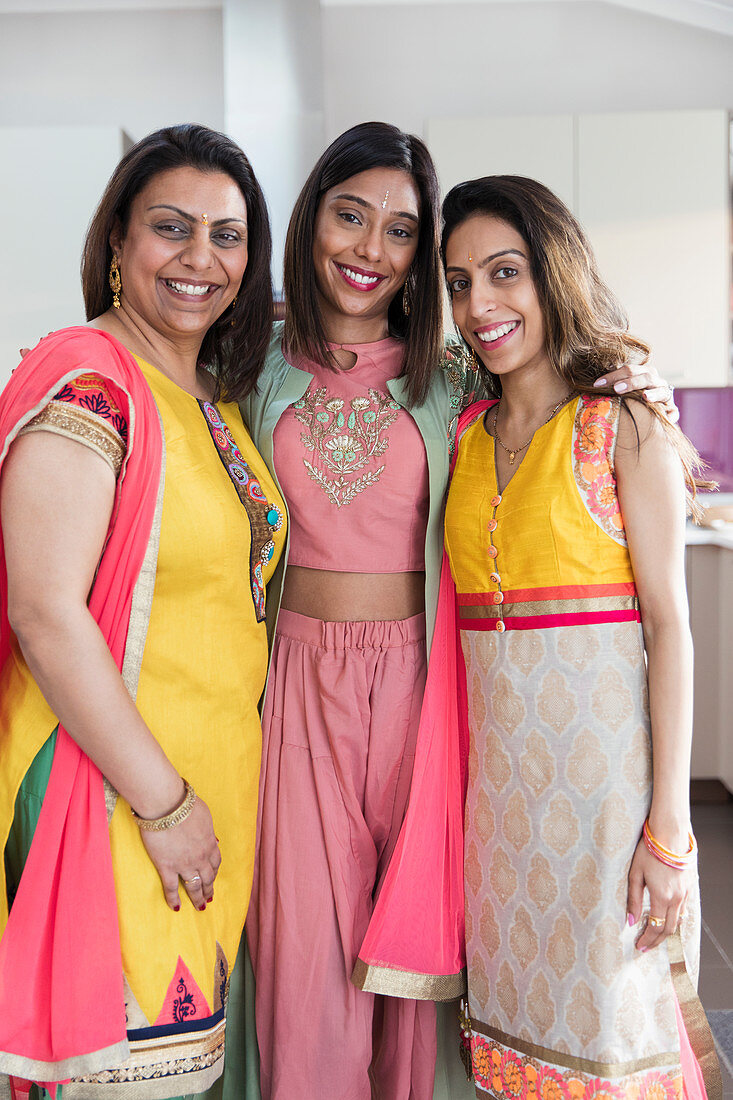 Portrait happy Indian sisters in saris