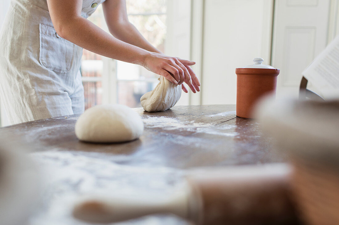 Teenage girl kneading dough baking in kitchen